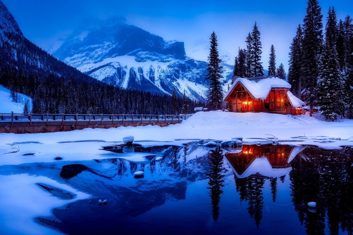 A snowy house by a lake in Canada