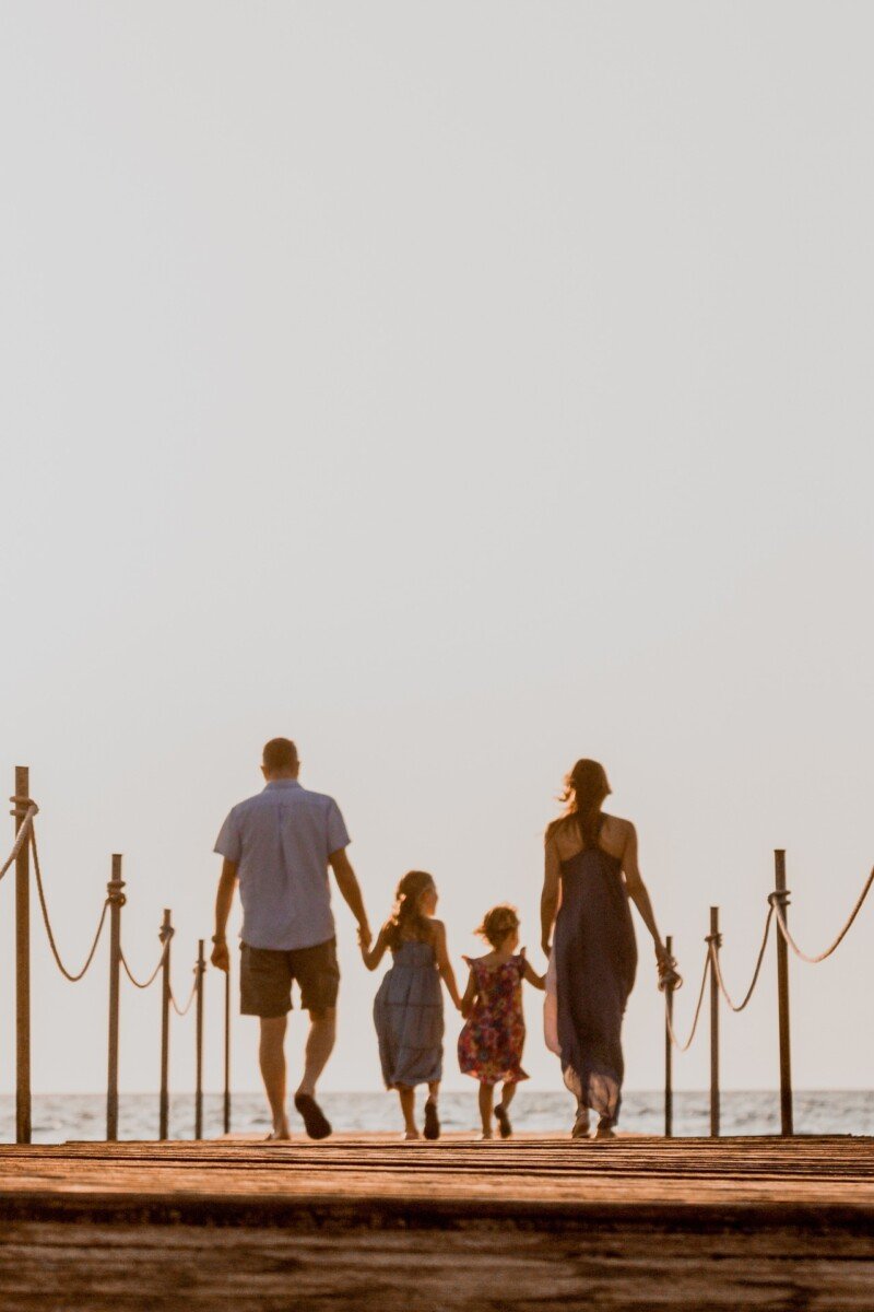 A family walk down a pier