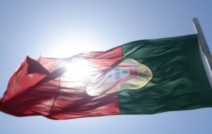 The flag of Portugal with the sun behind it