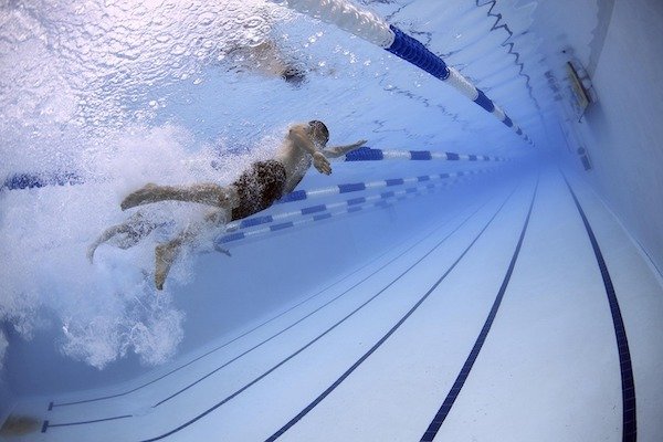 A man swims in a pool