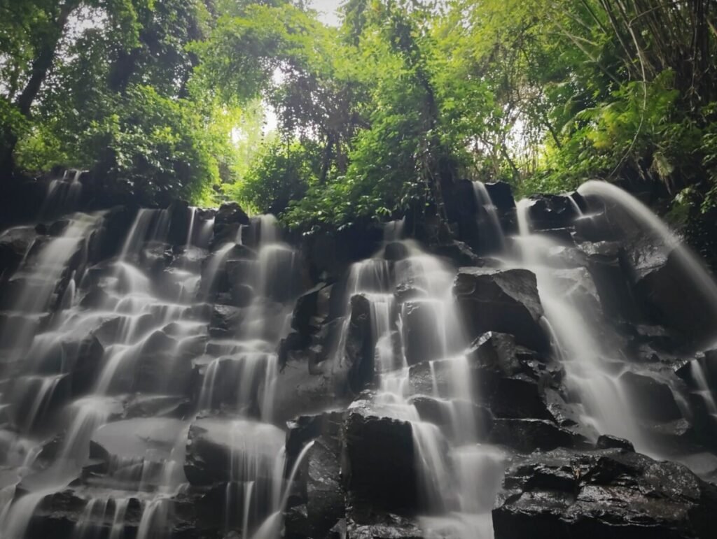 Kanto Lampo with cascading water over tiered rocks.