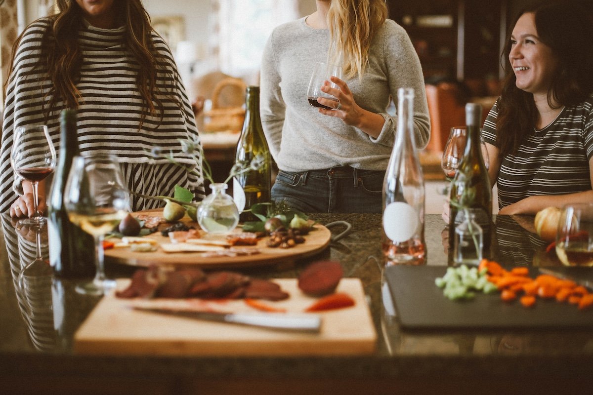 Friends at a table with wine and food