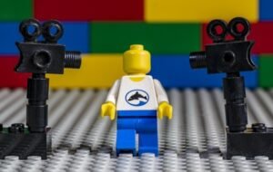 Lego figure with security cameras and colorful background