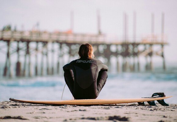 Surfers sitting on the beach