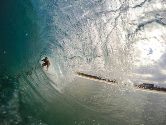 Surfers tunnel wave moment