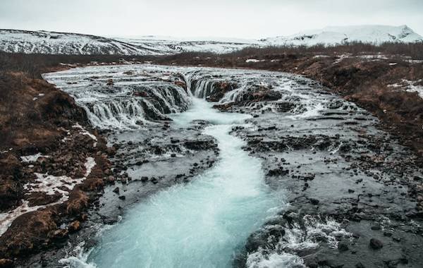 Hotsprings flowing through the jagged rocks in winter in Iceland