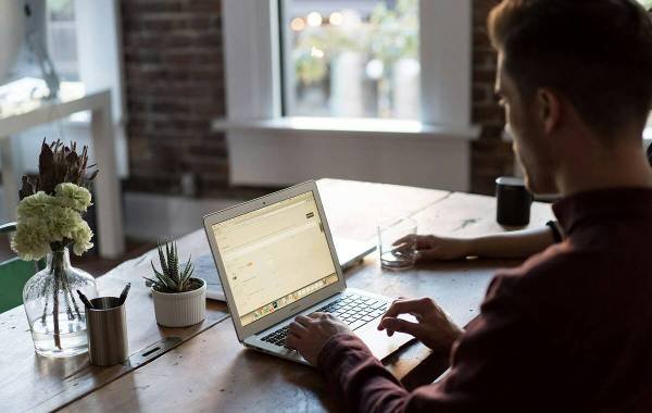 Man working on a laptop at a stylish home office setup.