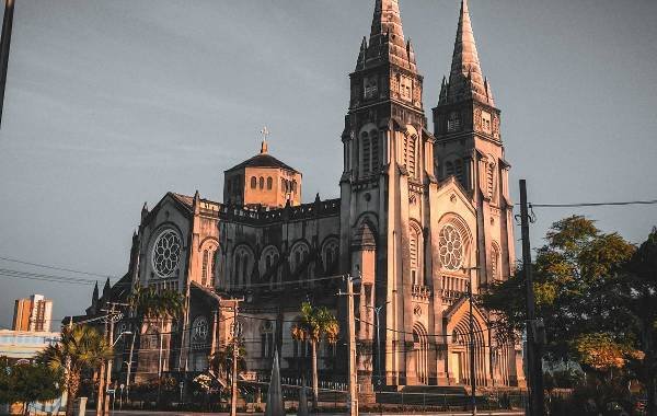 Historic cathedral in Fortaleza, Brazil, showcasing intricate architecture and stunning Gothic-style spires against a clear sky.