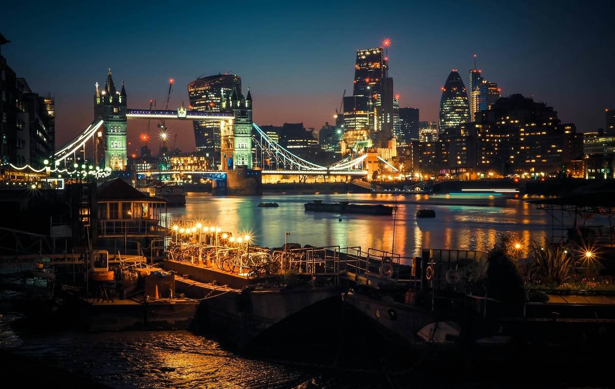 London city at night with a river running through it 