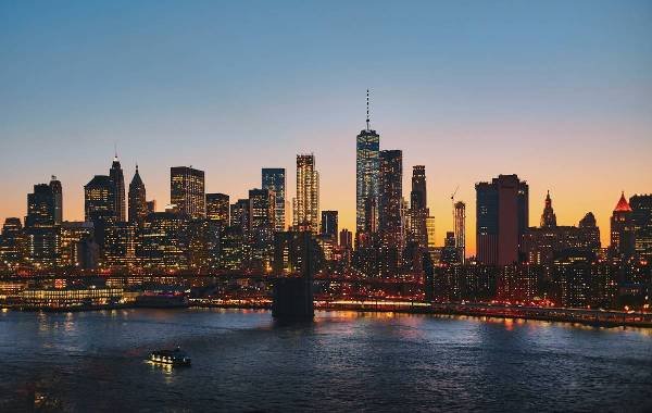 Sunset of new york over looking the sea with the buildings in the background