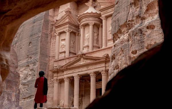 Entrance to petra with a man walking towards the entrance of the city