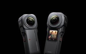 Dual-lens Insta360 action cameras with 1-inch sensors and LCD screens against a black background.