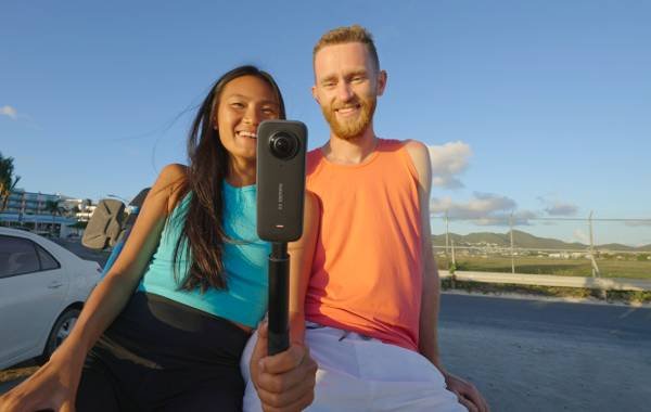 Couple using Insta360 X3 camera on a bright sunny day outdoors