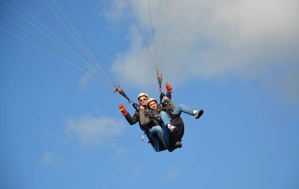 two people on a tandem paragliding in Bali