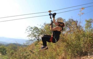 Woman zipling through the trees in costa rica