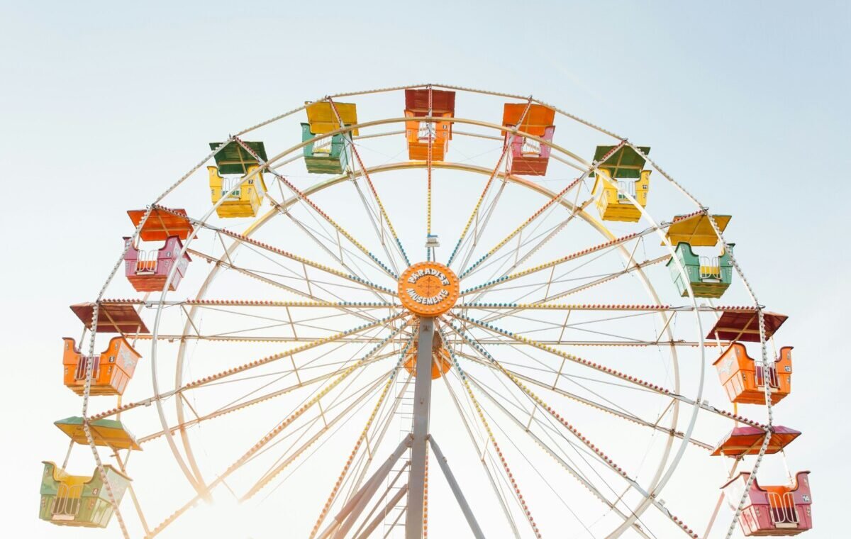Colorful Ferris wheel against a clear sky, capturing the essence of summer fun and outdoor festivities