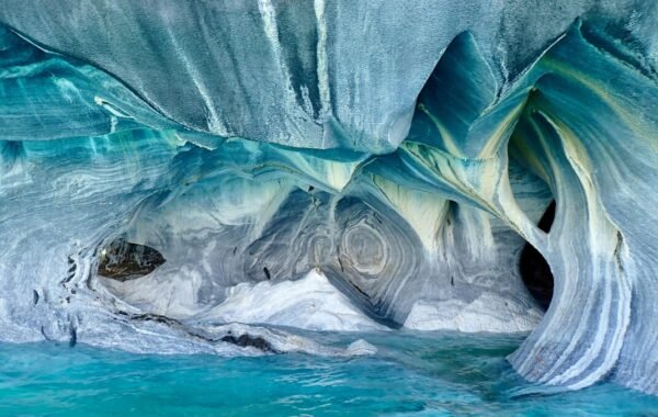 Stunning view of the Marble Caves in Chile, featuring intricately carved marble formations and vibrant turquoise waters reflecting natural artistry