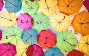 A vibrant display of colorful umbrellas hanging overhead, creating a lively atmosphere in the city